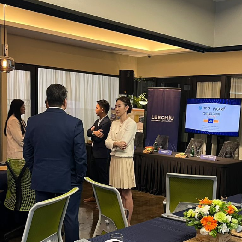 Figari and HGS executives networking before the contract signing ceremony